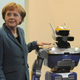 Image for article titled Why Is Angela Merkel Always Palling Around With Robots?